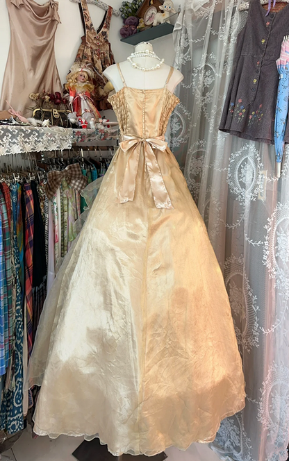A gold, backless, fitted long dress with a multi-layered, voluminous skirt; a ball gown R6298